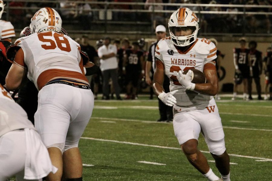 Ananias Vance '24 runs the ball. He was able to gain several yardages for the Warriors.