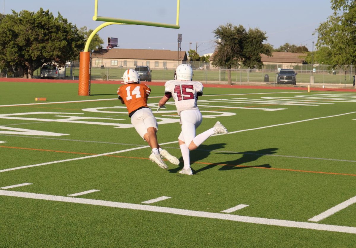 Weston Franz '27 sprawls out to make a diving catch in the endzone. The Warriors struggled to score points through the air with only one touchdown on the day keeping the score close. 