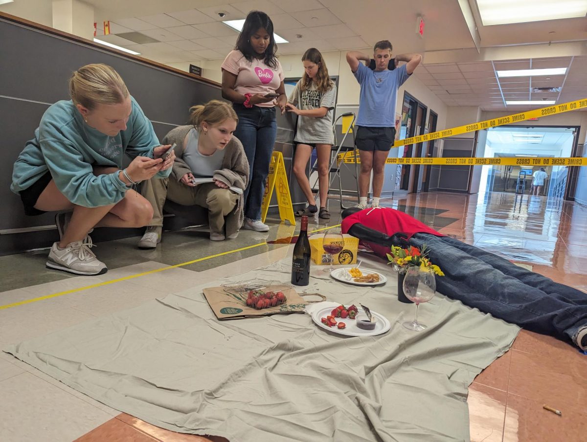 Concentrating, Elena Francis '25 investigates the mock crime scene with her partners. Forensics students try to solve the case through multiple exercises that test their investigative skills. "We practice our investigation skills with lots of hands on labs [in Forensics]," Francis said.