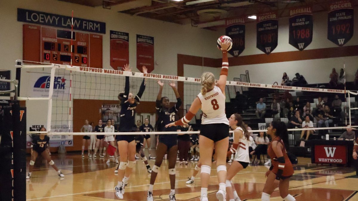 Fiercely swinging, Harper Zoll '25 catches air as she jumped off the ground to get a better angle to hit. Zoll works outside of practice to prepare for aiming her hits during games. "We watch film to watch and learn [the other teams] tendencies, where they like to stand, and who likes to play where so I can prepare for next days game," Zoll said. 