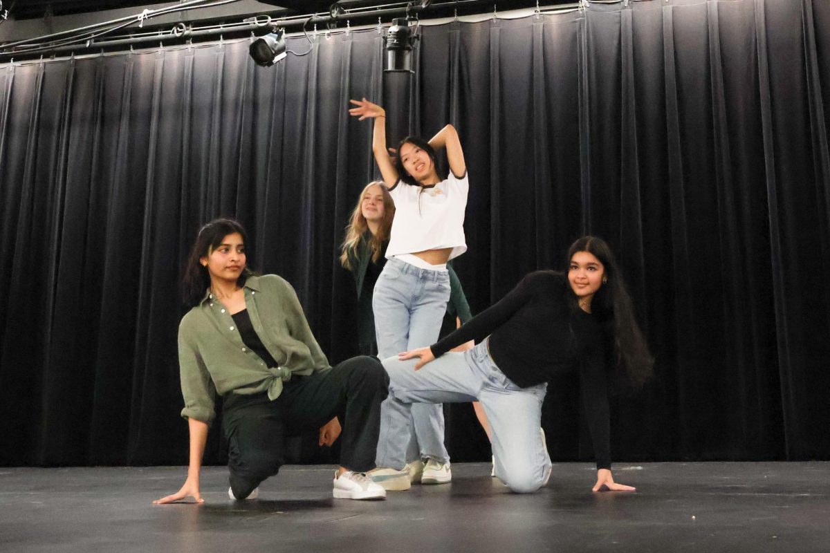 Kneeling, Dhiya Reddy '27 poses as she frames Jillian Riethmiller '27, Bella Wen '28, and Siya Majmundar '27 during their performance of 'Whiplash' by aespa. Reddy gave it her all as this was the only performance she participated in. "You’re expected to know the choreography when you come into your first practice," Reddy said. "You have around a month or three weeks to learn the choreography before the first practice where we set formations."