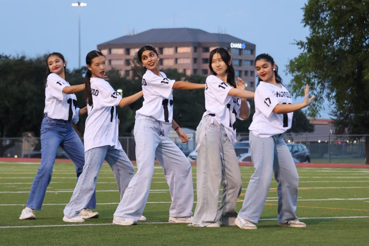 Striking a pose mid-performance, K-Pop Club members Sanjitha Girish '27, Bella Wen '28, Anandi Raj '27, Diane Kim '28, and Siya Majumdar '27 look to the crowd. Sporting matching KCROOKD jerseys to represent their group name, the team performed to popular songs such as 'ANTIFRAGILE' by LE SSERAFIM and 'Gnarly' by KATSEYE.