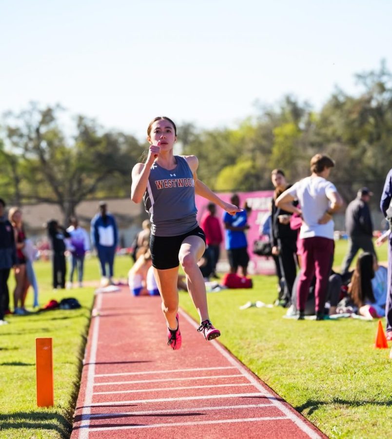 Violet Hewitt '25 begins her first jump for the triple jump event.