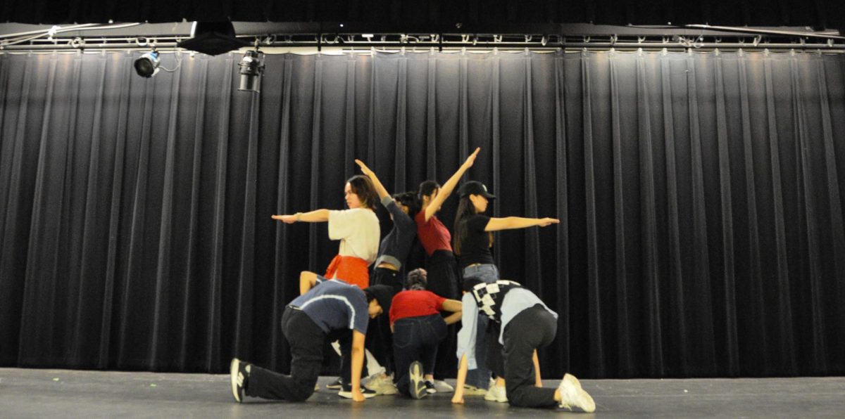 Standing together before their dance began, God's Menu performers pose, setting the tone of the dance. K-pop Club members rehearsed for six weeks for their second to last performance, the Spring Showcase, offering ample opportunities to perfect their choreography. "I was excited to dance with complex group formations and movements," dancer Ninju Prem '25 said.
