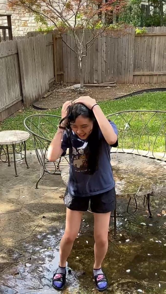 Holding her wet hair, Elaine Liu '28 laughs after being drenched in ice water while being recorded by her mother. While Liu initially didn't plan on doing the challenge, she was motivated to participate upon learning it was for mental health awareness.