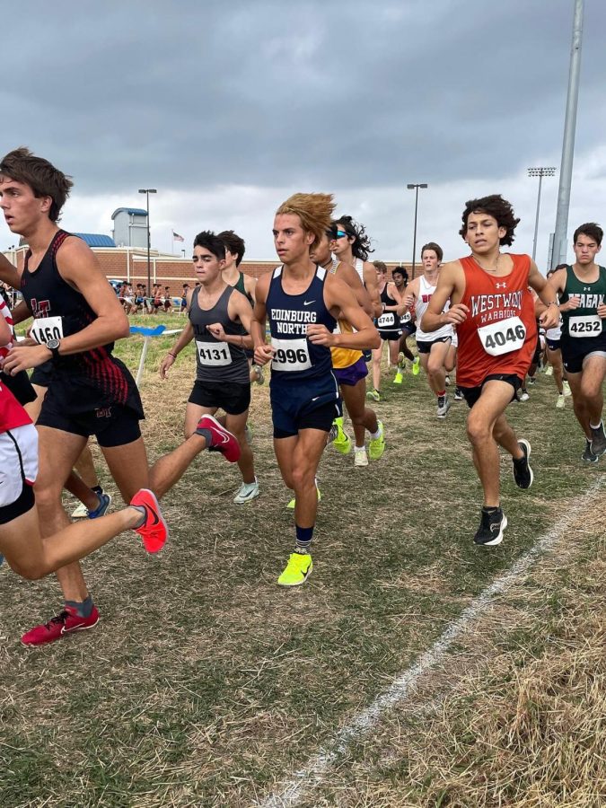Korban Murphy '24 attempts to pass other athletes to move up the ranks. Murphy placed the highest out of all the varsity boys, with his 26th place finish leading the team to their qualification. 