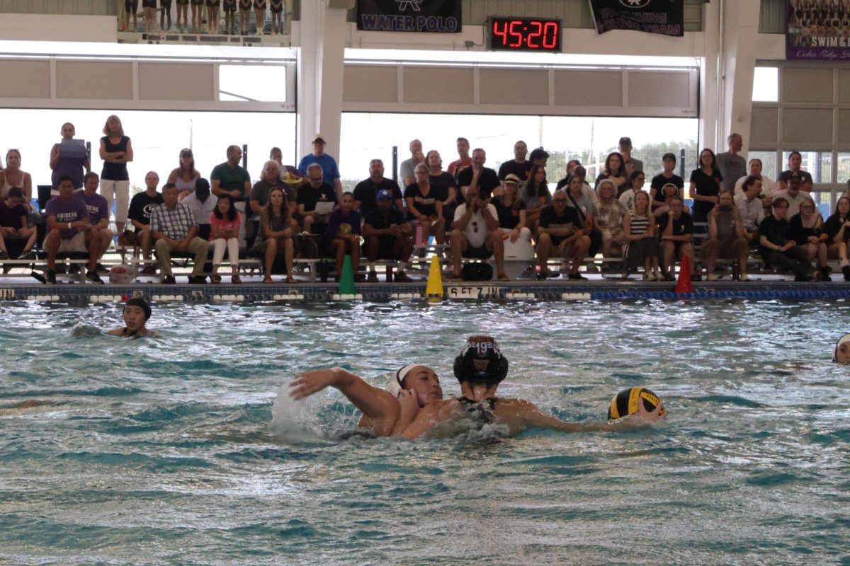 Audrey Derdeyn '26 fends off Cedar Ridge, clearing the way for an attempt to pass the ball. 