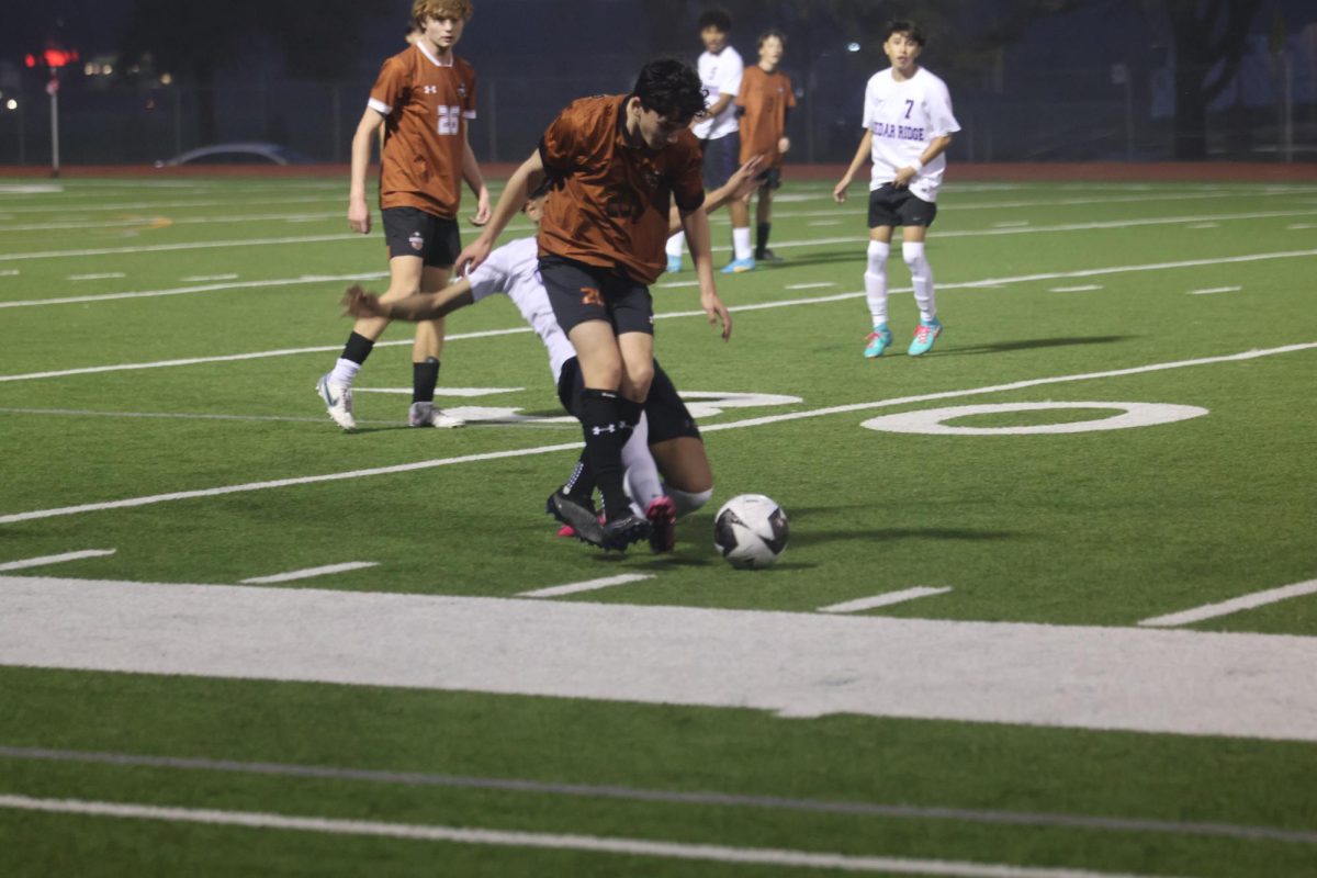 Lucas Casco '27 defends against a Cedar Ridge Raider. The Warriors were able to keep the Raiders out of their half for most of the game with good defense. 