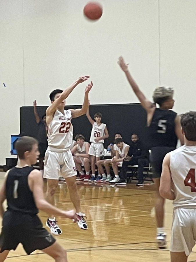 Patrick Jeng '26 goes up for the three pointers to increase the Warriors lead. Jeng hit two three-pointers in the game. 