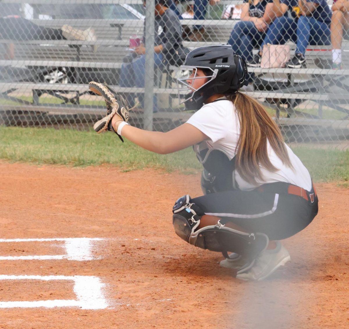 Catcher waits as Nadia Kareem '28 prepares to pitch a strike.