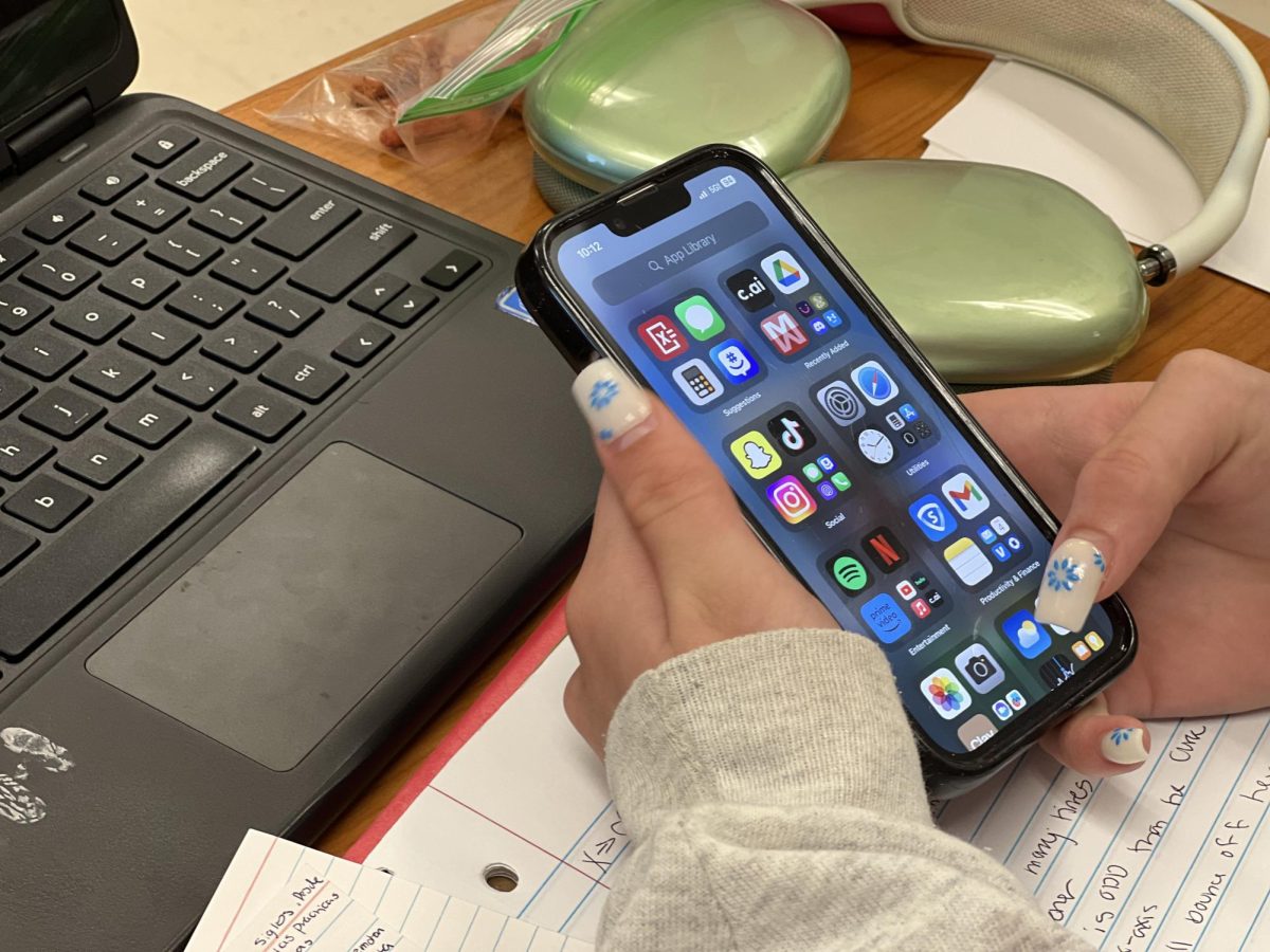 After doing her work, Payton Vopat '26 uses her phone. While educators often believe phones have a strictly negative effect on students, many students see it as a way to spend their free time.