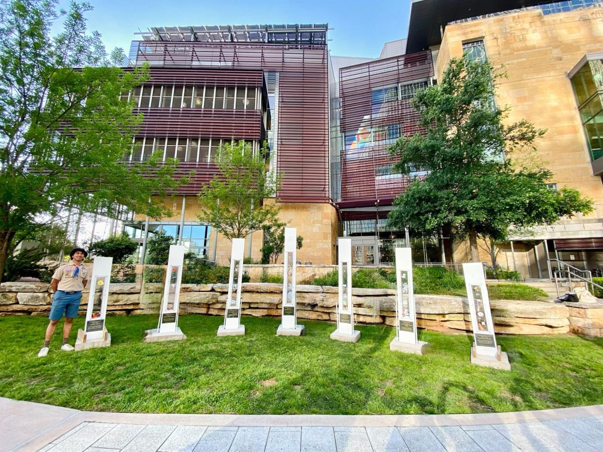 Vaishnuv Thiagarajan stands proudly in front of his completed monument in front of the Austin Public Library. Each pillar that Vaishnuv built himself represents a sector of frontline service.