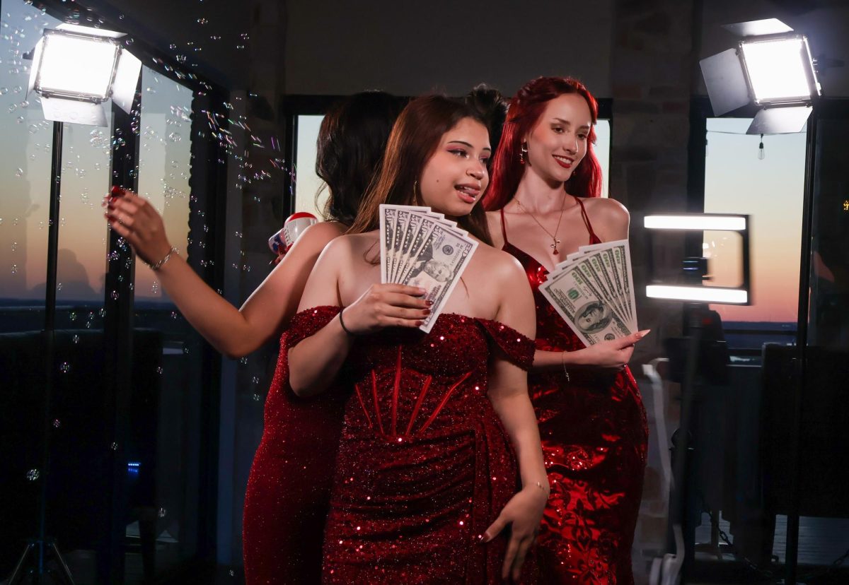 As their friend shoots bubbles in the air, Marley Huston '26 and Nina Stockinger '25 stand on a platform, posing for the 360 photo booth's rotating cameras. The photo booth attracted many dancers who reveled in the unique twist on a traditional photo booth.