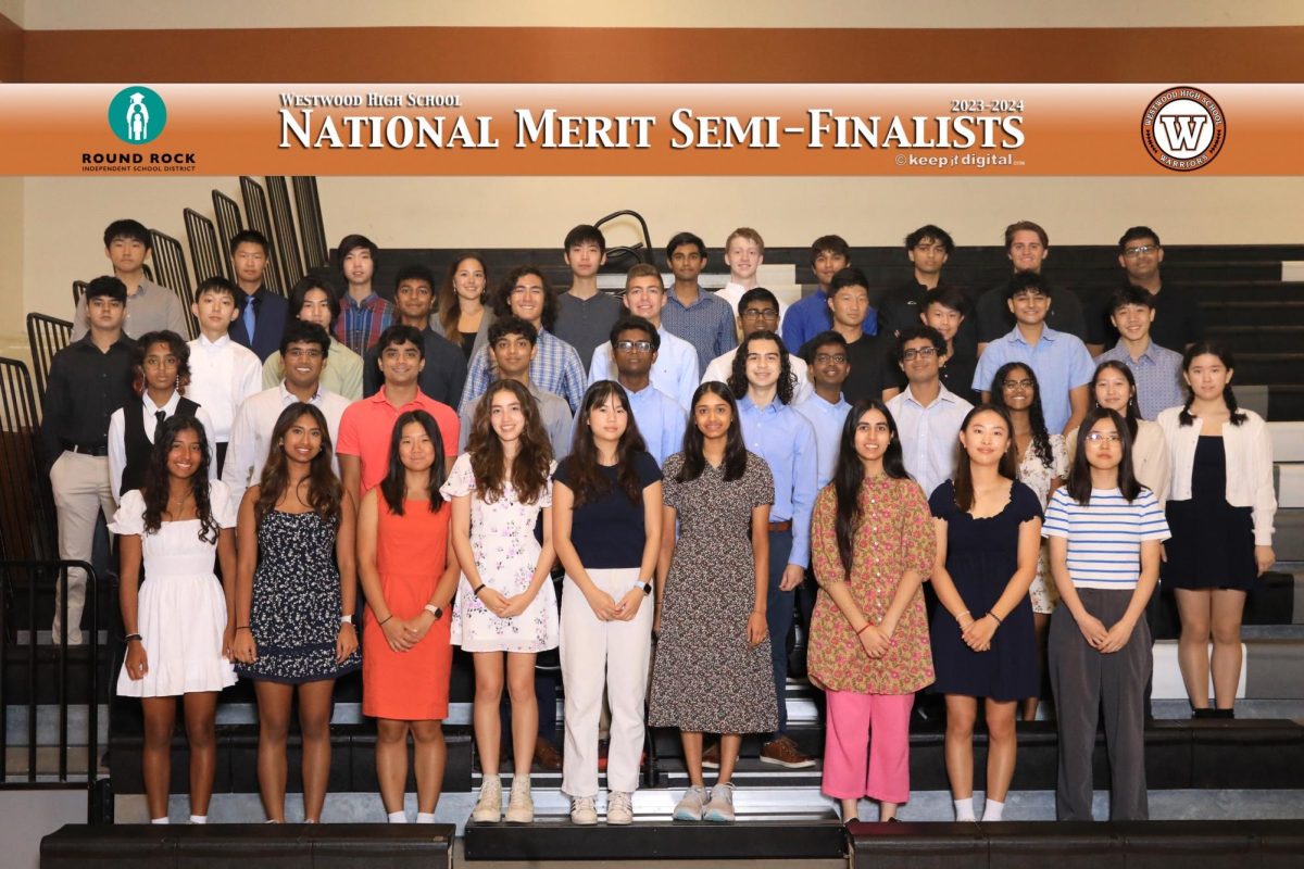 Standing on the bleachers in the small gym, Westwood's National Merit semi-finalists pose for a photo after the awards ceremony. The biggest group of winners in Round Rock ISD, a total of 45 seniors won this award: a result of scholarly dedication and diligence.