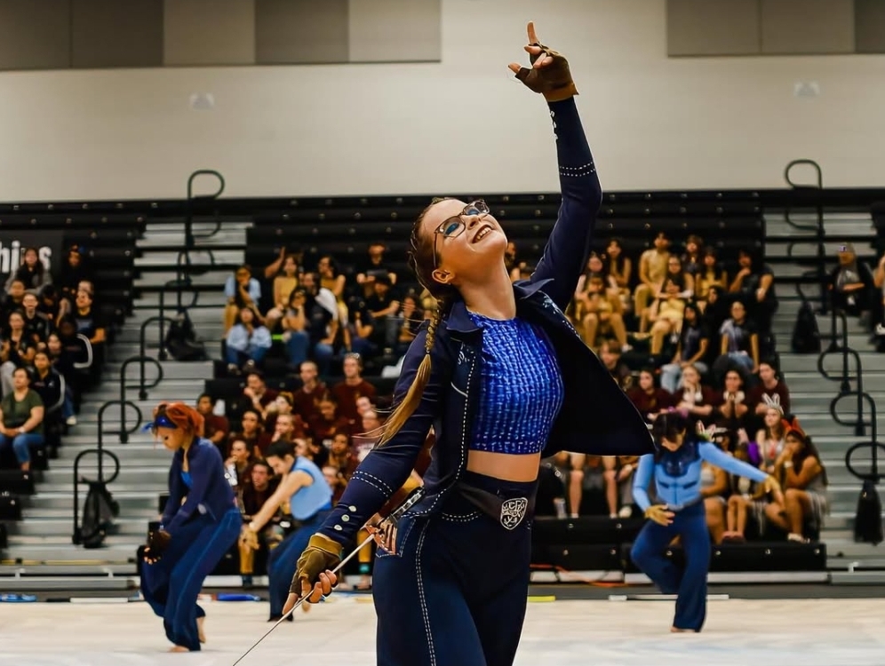 Taking a pose with her sabre, Color Guard Captain Martina Ciacci  '26 performs the intro of the Varsity team's show "And I think to Myself..."
