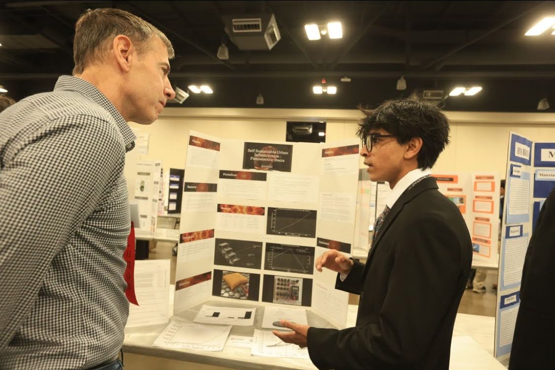 Speaking with a convention attendee, Vishnu Mahadasu ‘26 presents his research project, Self Sustainable Urban Infrastructure: Piezoelectric Stairs, on Thursday, Feb. 20 at the Austin Energy Convention Center. He shared his ideas with multiple convention viewers and judges alike, a vital element of any presentation. “Do your research, get resources. Start as soon as you can. Don't wait for the perfect opportunity because it might not ever come at all,” Mahadasu said.
