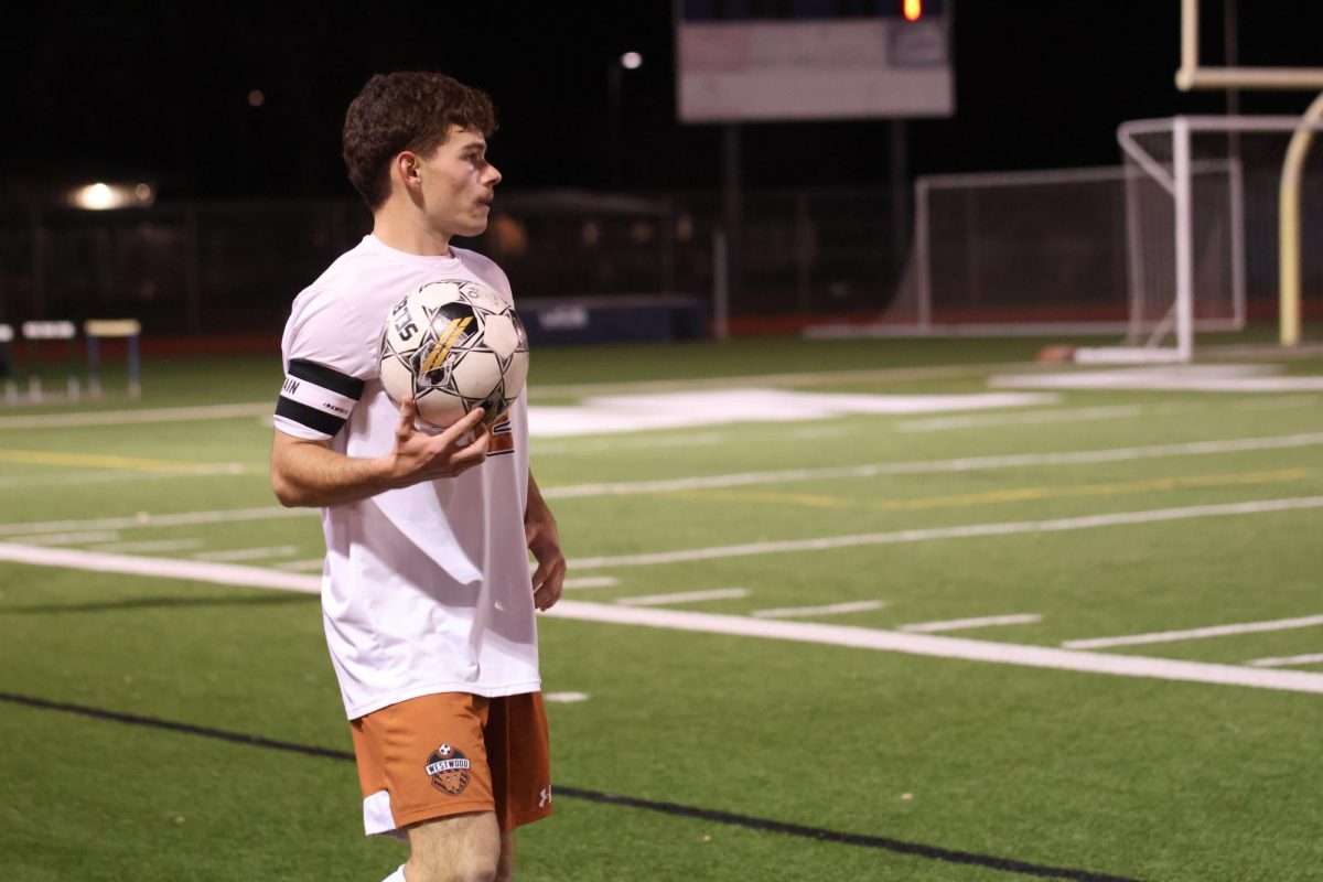 Jorge Pena '24 scans the field for an open teammate during a throw-in. Throughout the match he was essential for many of Westwoods key plays, and helped lead the Warriors to their late game goal.