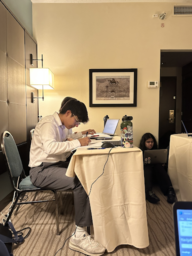 Focused, Shrey Birmiwal ‘25 prepares to give a Public Forum speech in his Triple-Octafinals round at the TFA state tournament. Birmiwal and his partner, Siyona Jain ‘25, advanced to the Double-Octafinals round of the tournament.