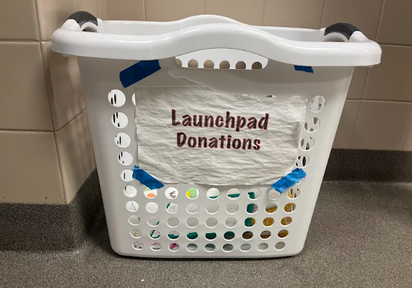 In a women's restroom, a repurposed laundry bin stores menstrual products for people to use, an effort to combat period poverty. Since its founding in 2018, LaunchPad has worked with HOSA to collect and distribute menstrual products around Westwood's restrooms for student's use.