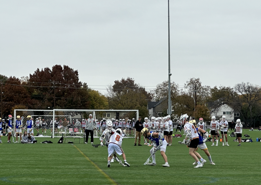Richard Xue ‘26 performs a face-off against an Anderson opponent at this weekend’s lacrosse tournament.