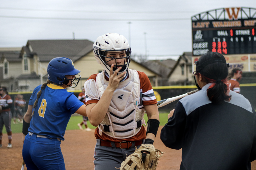 Kylie Wardlow '23 readjusts her softball helmet at the end of the inning.
