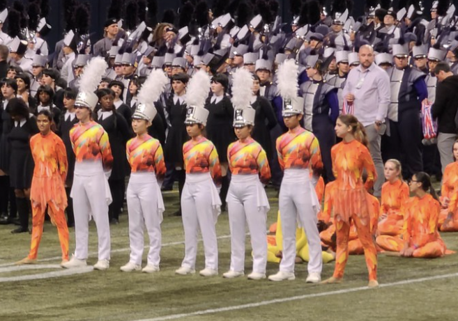 The Drum Majors stand before the band eagerly waiting for the results for finals to be announced at the BOA St. Louis Super Regional. The band had performed their show Birds on a Wire at multiple competitions before the Super Regional with outstanding results, so the Warriors were expecting nothing short of excellent results. 
